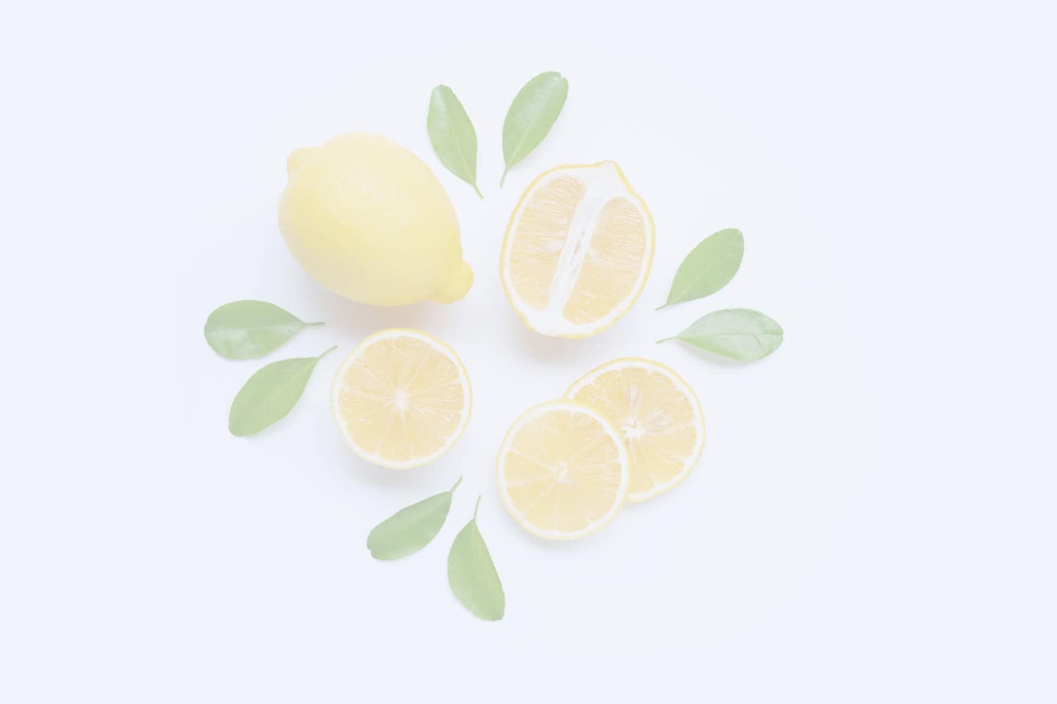 Lemon slices with fresh green leaves on a white background, highlighting citrus freshness and natural oils for health and wellness purposes.